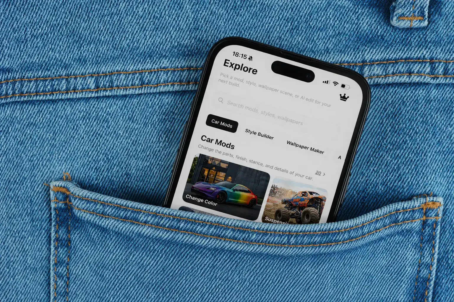 Car AI app shown on a phone inside a denim pocket